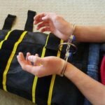 What to know about ICE’s use of a full-body restraint device known as the WRAP